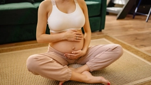 Maternité en pleine conscience : Femme enceinte caressant tendrement son ventre
