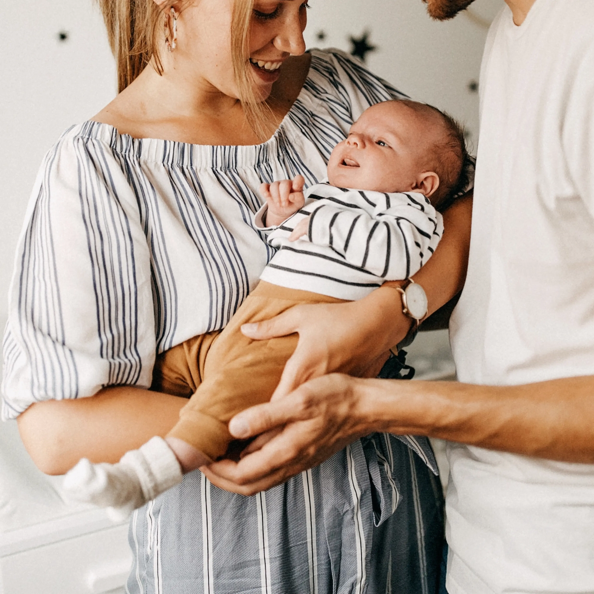 Parents tenant leur nourrisson dans un moment d’échange et de soutien, illustrant l’accompagnement des familles en établissement d’accueil du jeune enfant (EAJE).